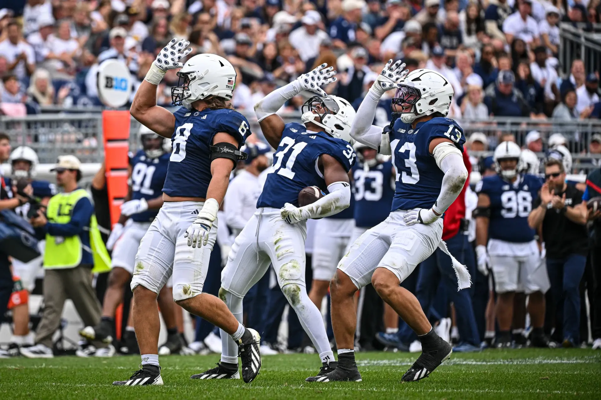 Penn State players celebrating on the field