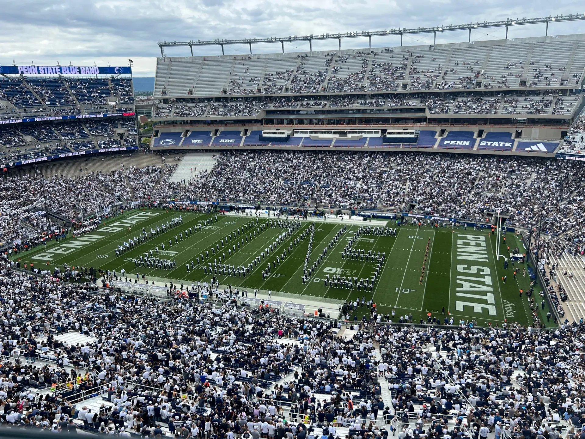 Penn State Blue Band on the field in a packed stadium
